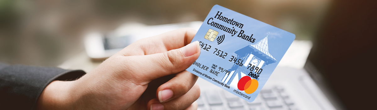Close up of Hometown Banks Debit Card held in a woman's hand 
