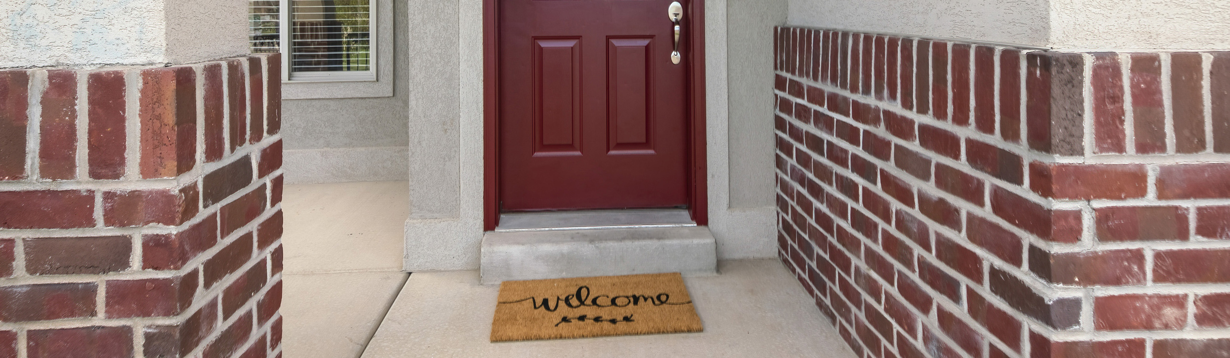 front door of home with Welcome mat